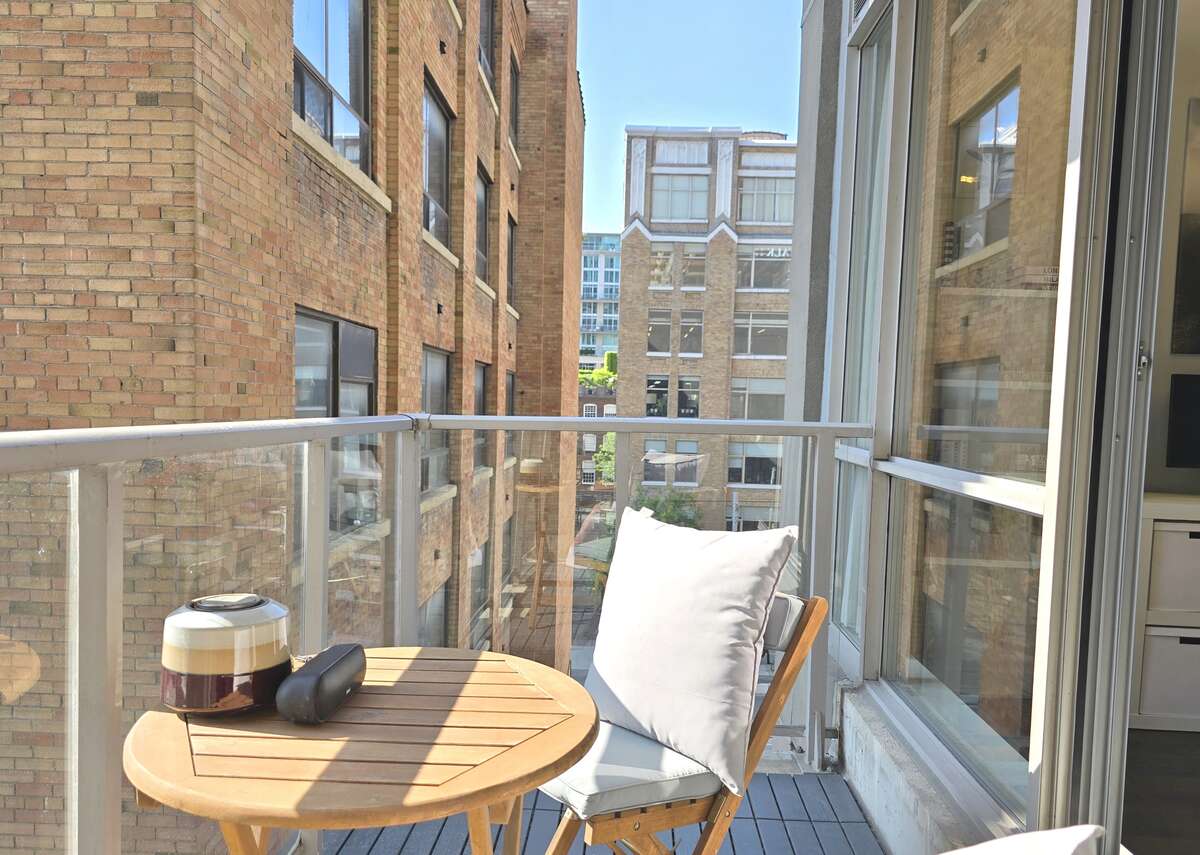 Stylish balcony with contemporary decor and a scenic cityscape backdrop.