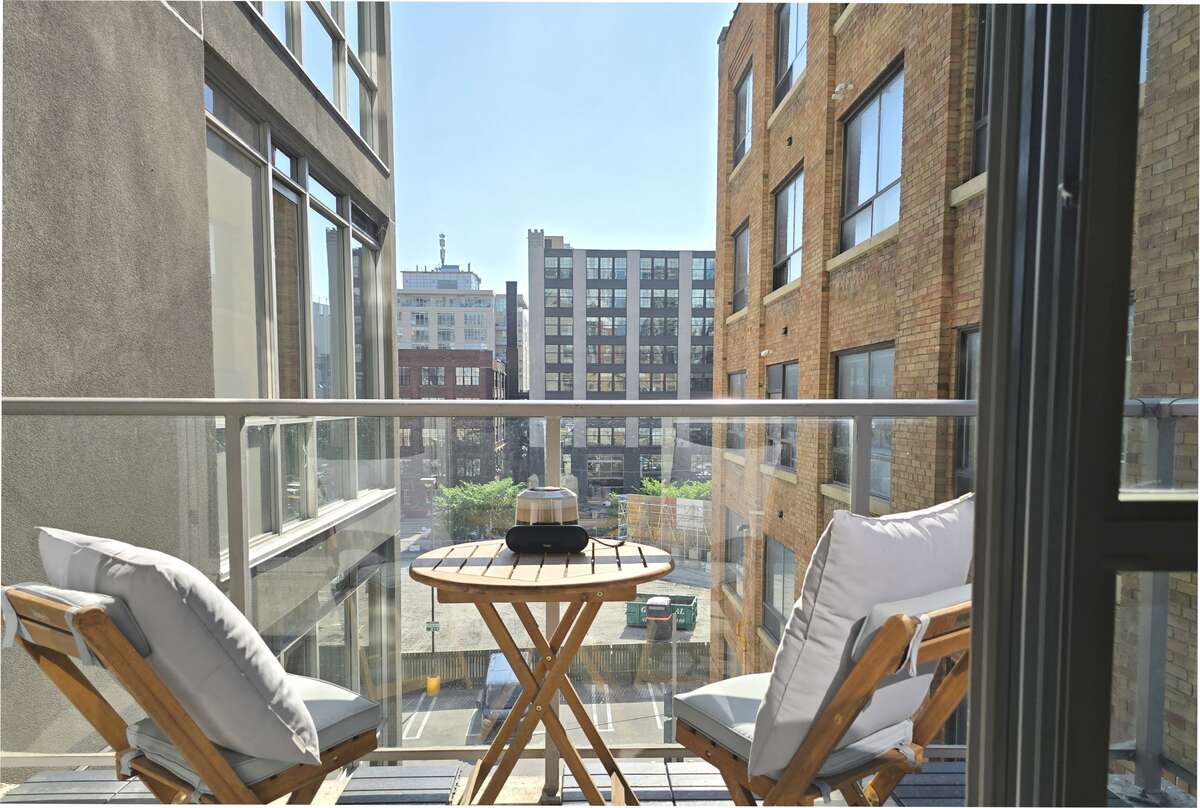 Charming balcony with city views, perfect for relaxing and enjoying the outdoors.
