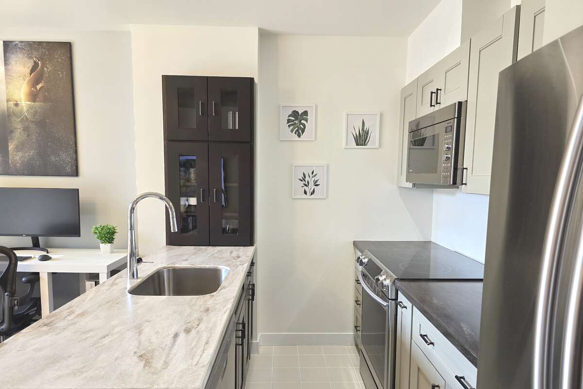 Elegant kitchen features stylish cabinetry and sleek countertops.