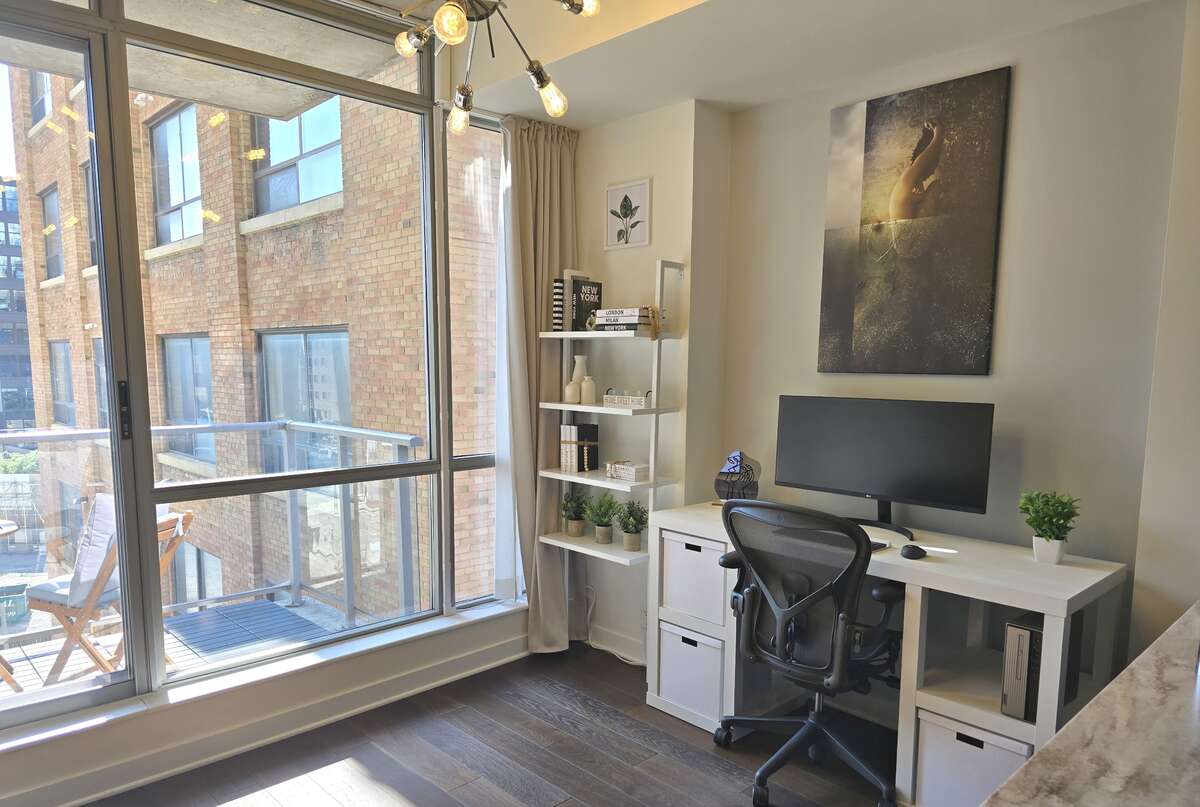 Bright and modern home office with large windows and ample natural light.