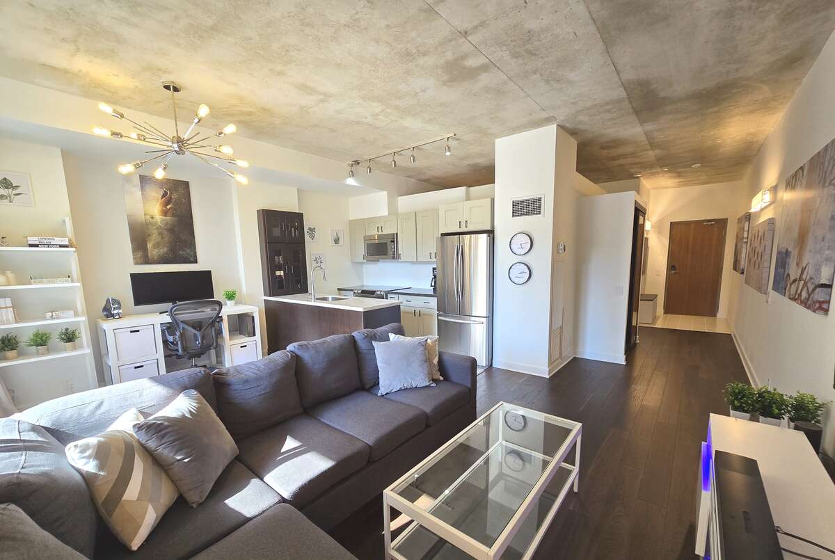 Open concept living area featuring a sleek kitchen and plenty of seating space.