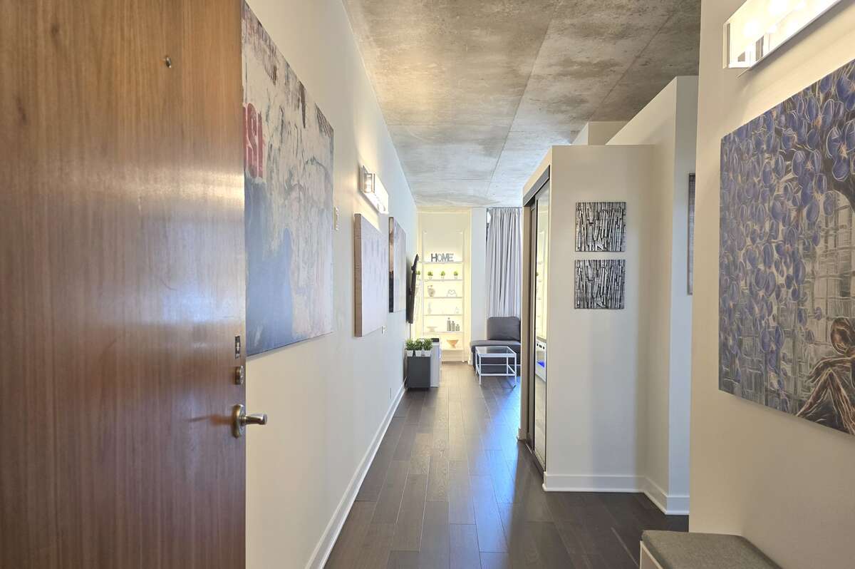 Welcoming entryway with modern lighting and clean, updated finishes.