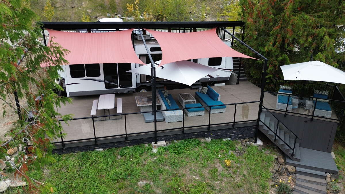 Large deck, shade sails, glass railing, and outdoor living space