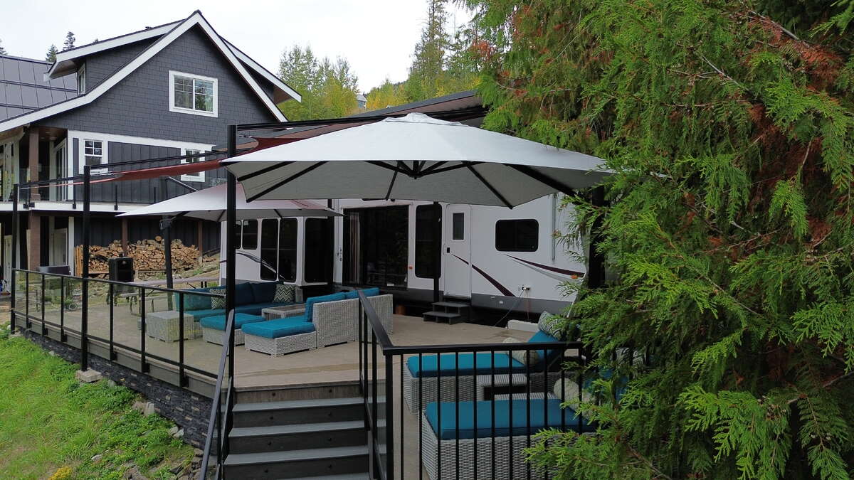 Outdoor living area surrounded by mature trees