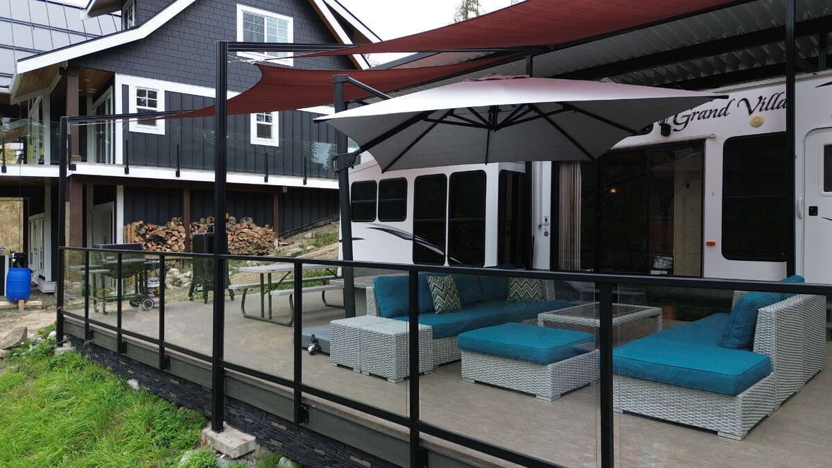 Spacious deck with lounge area and glass railing