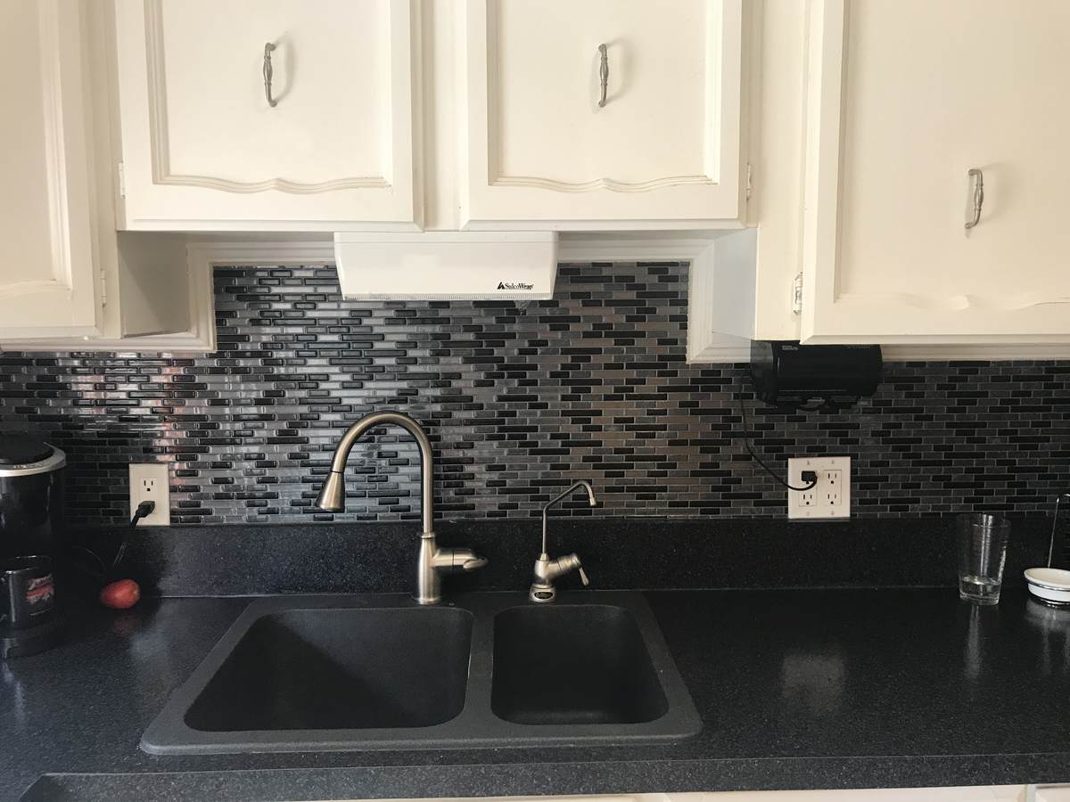 New black granite sink, back splash and a black stone Arbrite counter top.