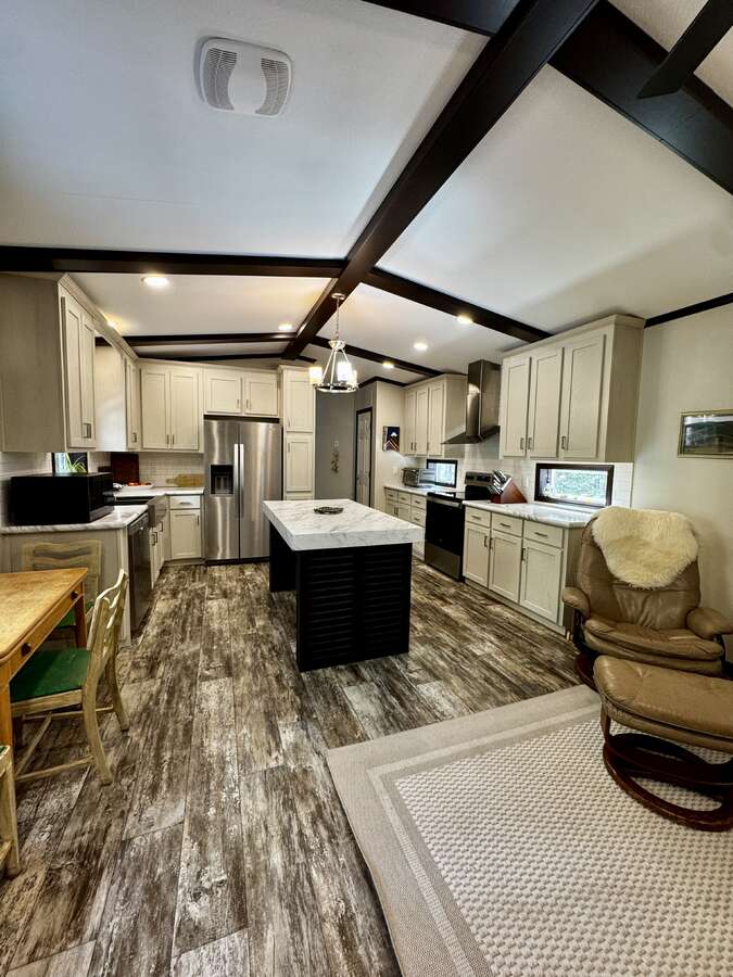 view of living room and kitchen from door