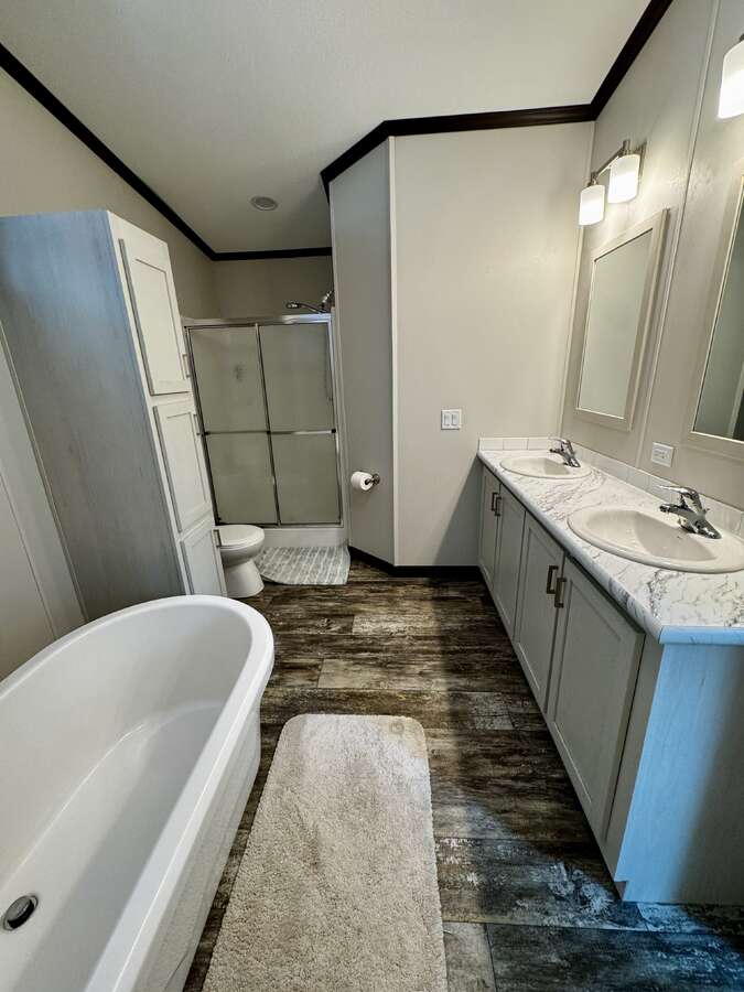 Large soaker tub, shower and his and hers sinks with plenty of cupboard space