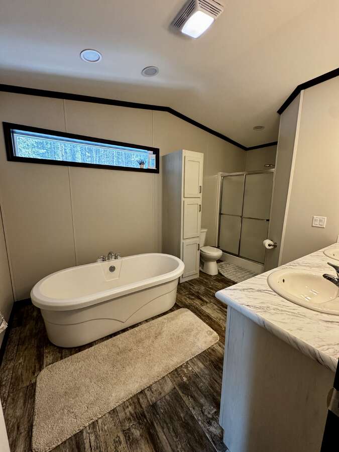 Large soaker tub, shower and his and hers sinks with plenty of cupboard space