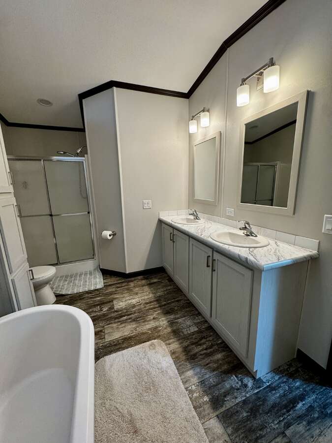 Large soaker tub, shower and his and hers sinks with plenty of cupboard space