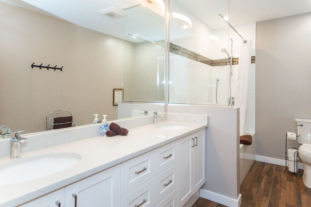 Full bathroom with double sink and shower/tub