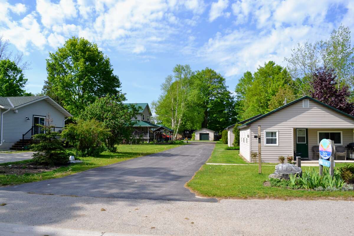 Mill Road Corner – Cozy 2-bedroom cottage with covered front porch and sunset views.