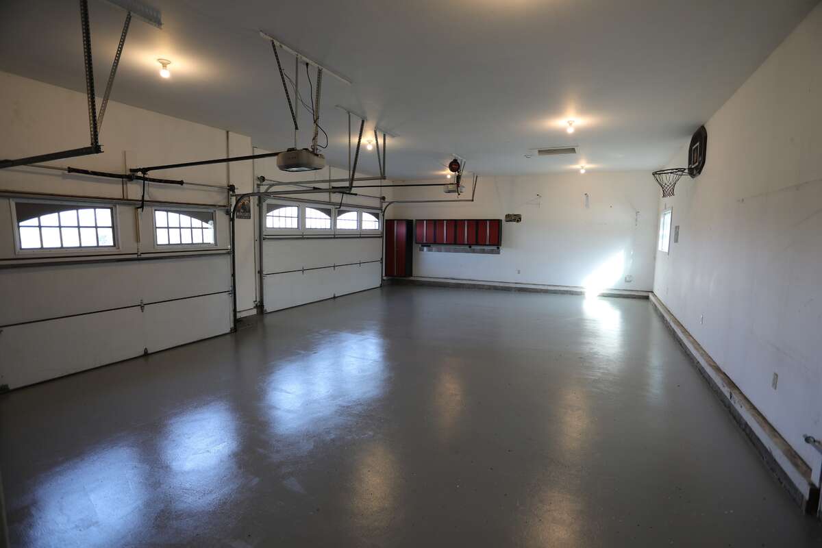 In-floor heated 37 ft x 26 ft garage with a 240v/50 amp plug, a side door to swim spa