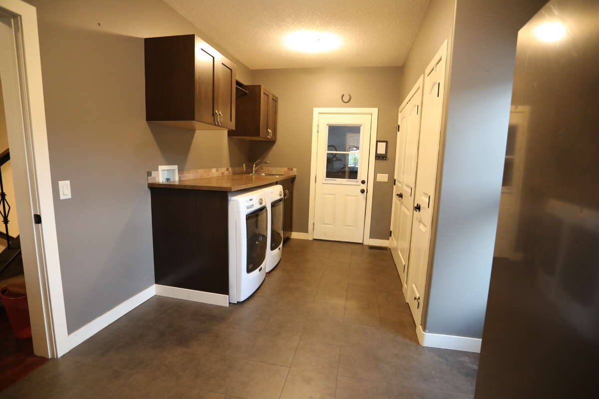 Mudroom and laundry with newer Maytag washer and dryer