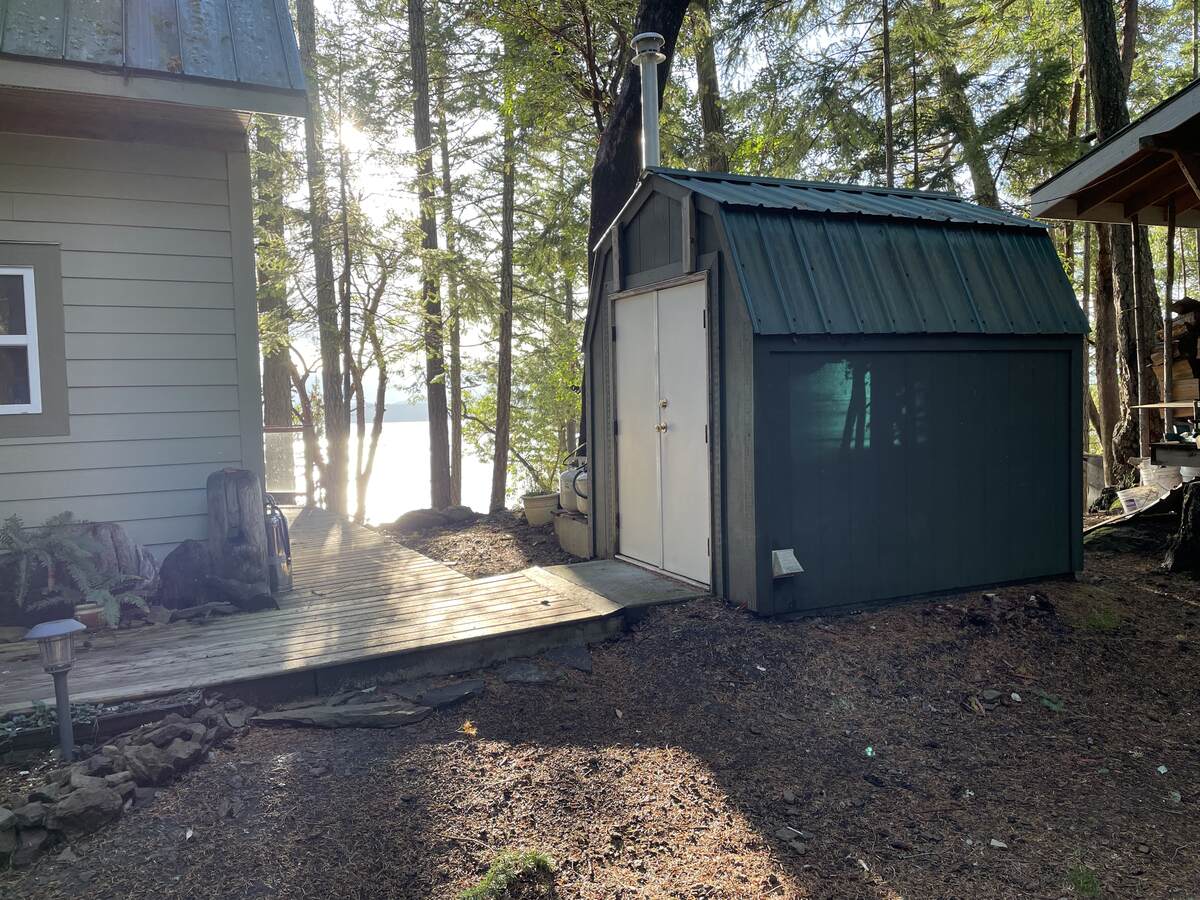 Utility shed for generator, batteries, converter, on demand hot water, and washer/dryer.