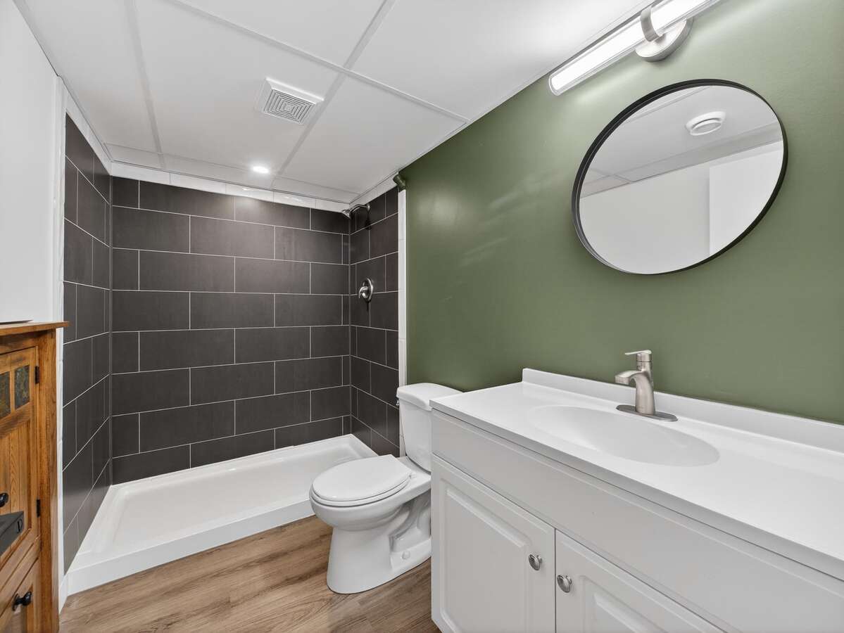 basement bathroom with walk-in shower and great storage