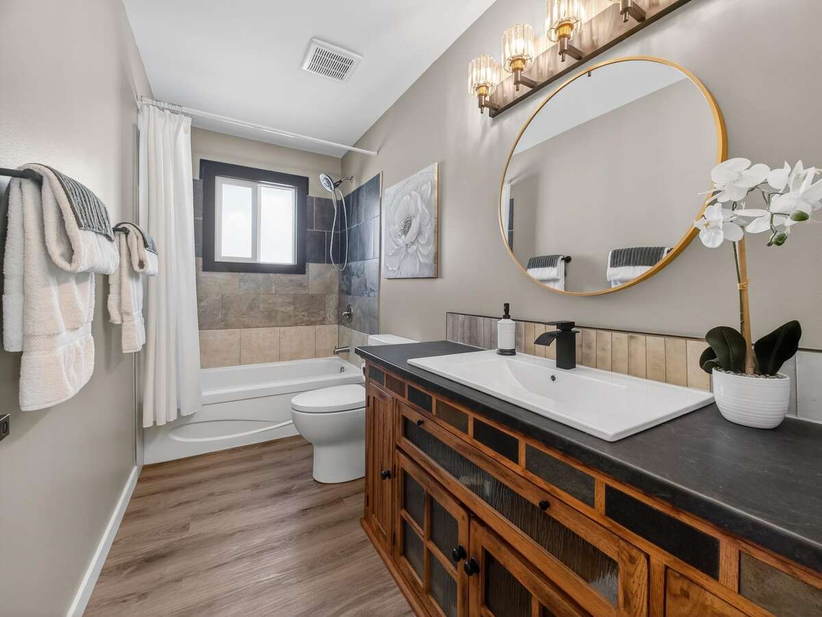 large vanity with lots of  storage, pairing nicely with the kitchen island