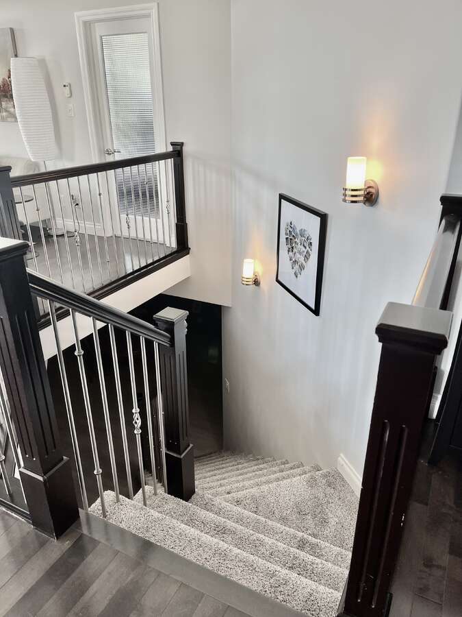Upgraded spindles on beautiful central staircase to below.