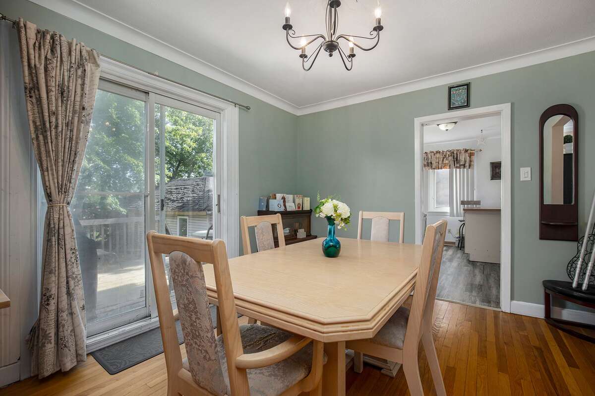 Dinning Room opening onto a 2-level wood and patio time deck - August 2022