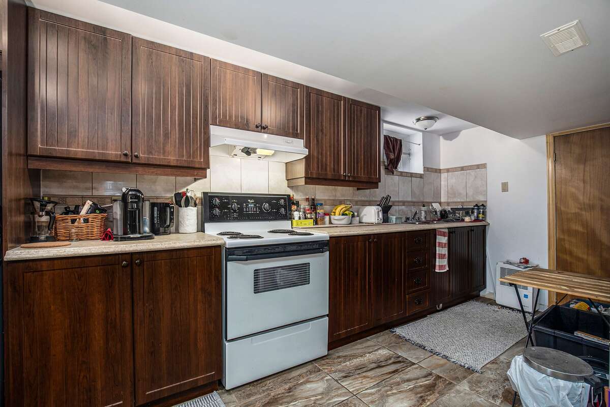 Basement suite kitchenette, appliances included (refridgerator, self and easy-clean stove, deshumidifier draining automatically into the well, microwave)
