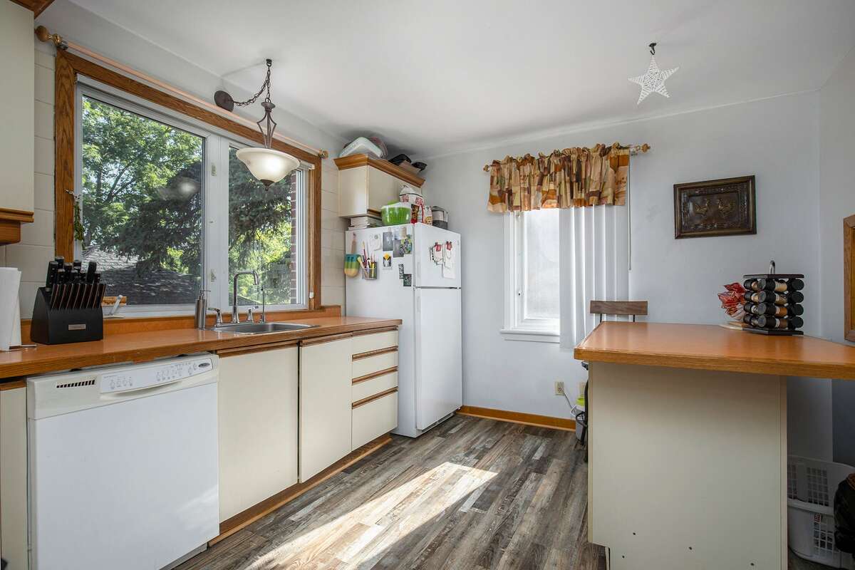 Main floor eat-in kitchen with Island on wheels and Storage, all appliances, curtains, blinds included (Easy Clean Stove, Refridgerator, Dish washer)