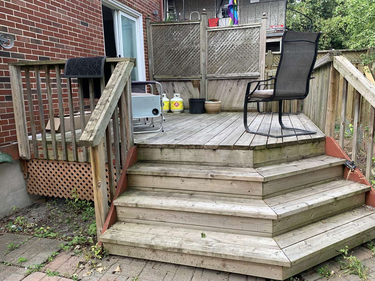 Backyard Wood patio deck of approx. 16x12 ft with stairs landing onto a 11x10 patio tiles deck