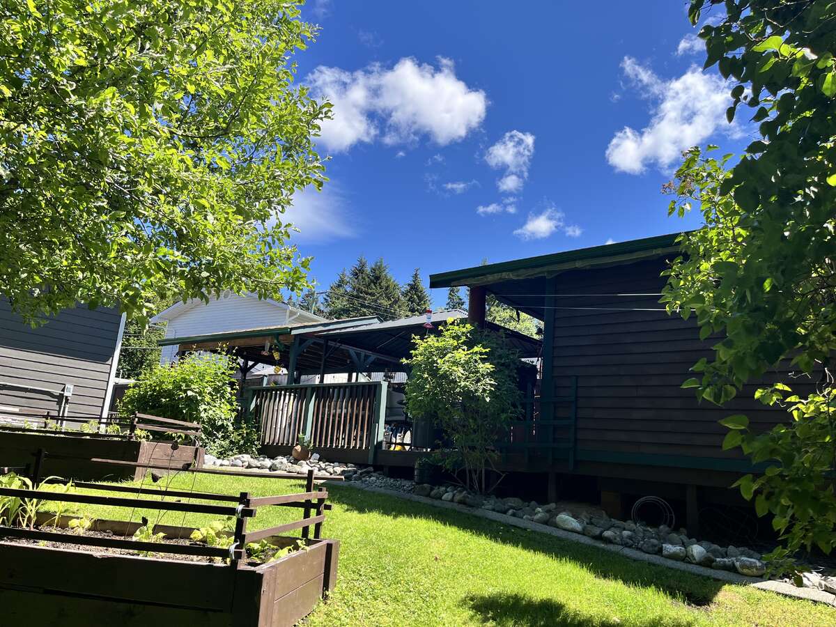 Looking up at the covered deck, gazebo and large shed