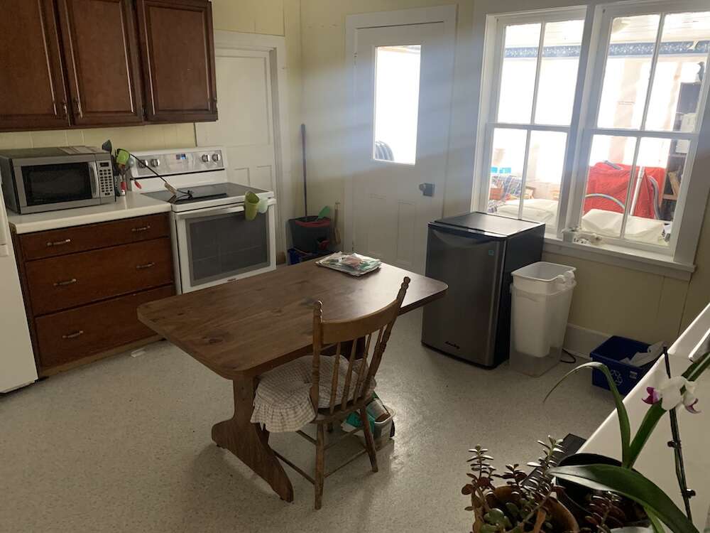 Kitchen with adjoining sunroom and workshop entrance