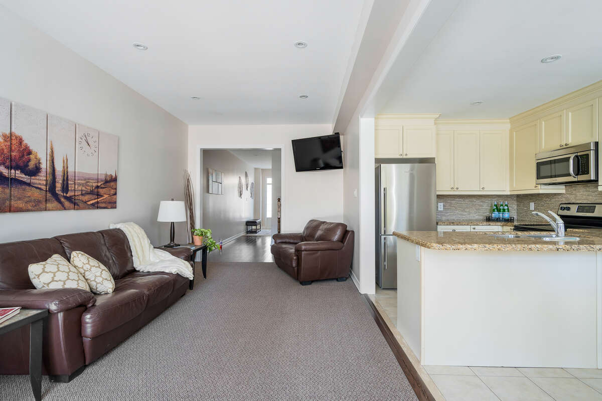 Main level living area, kitchen, dining area looking to front foyer