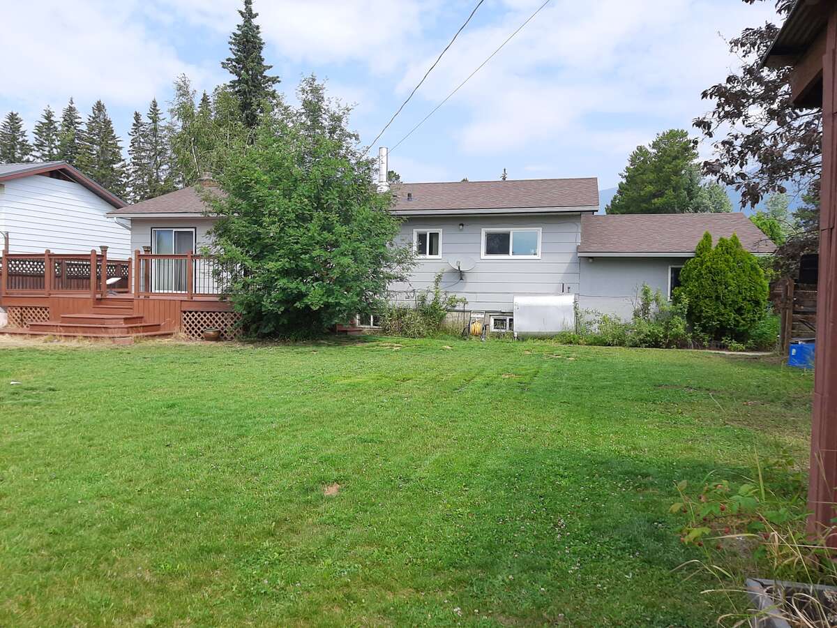 View north to the house. Garden shed and wood shed on the right.