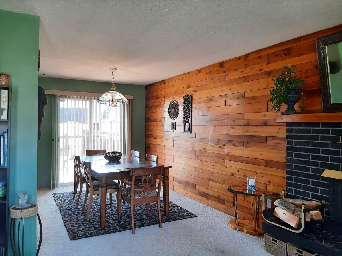 Dining space fits large family table and leads to deck sliders