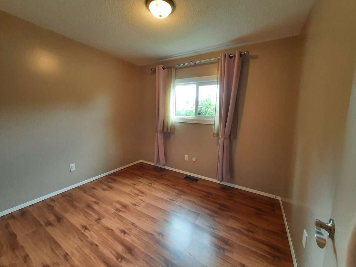 Bedroom 3 - new flooring, paint, fixtures, window and coverings.