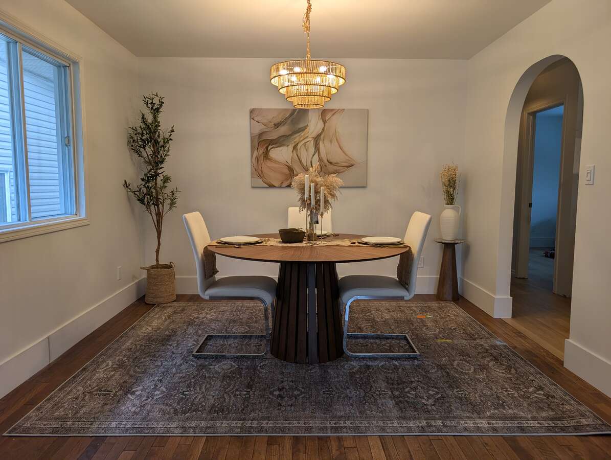 Gorgeous original hardwood flooring with new archway to kitchen