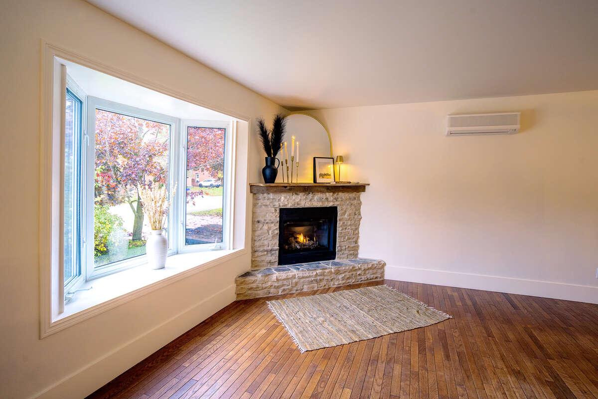 Cozy natural gas fireplace and beautiful bay window