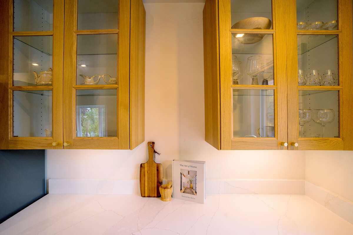 White Oak Glass Cabinetry with undermount lighting