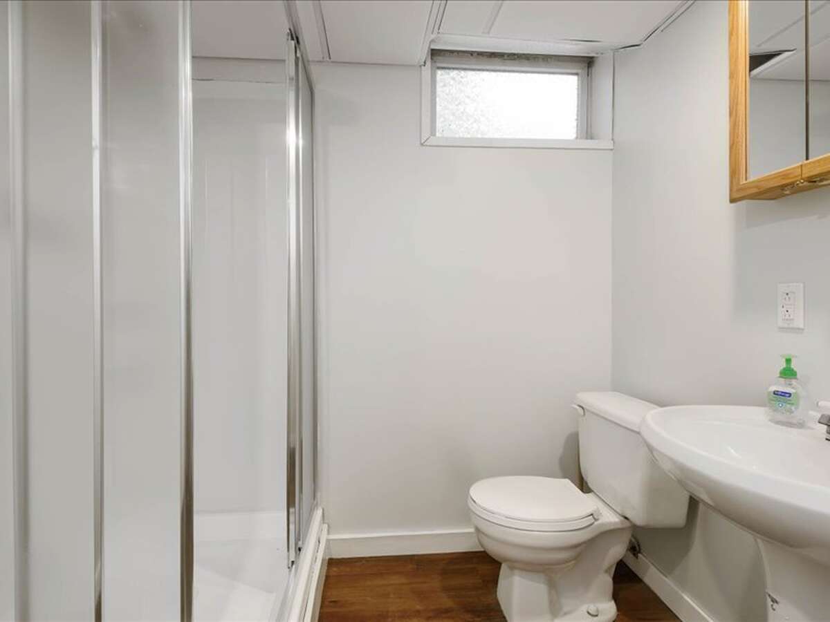 Basement Bathroom: 7' 9" L x 6' 9" W | Stand-up Shower, Vinyl Plank Flooring, Drop Ceiling with Fan