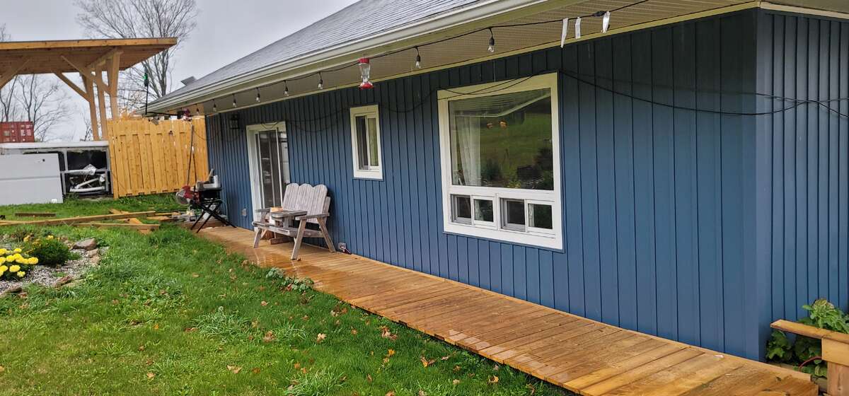Back of house with side walkway to pool