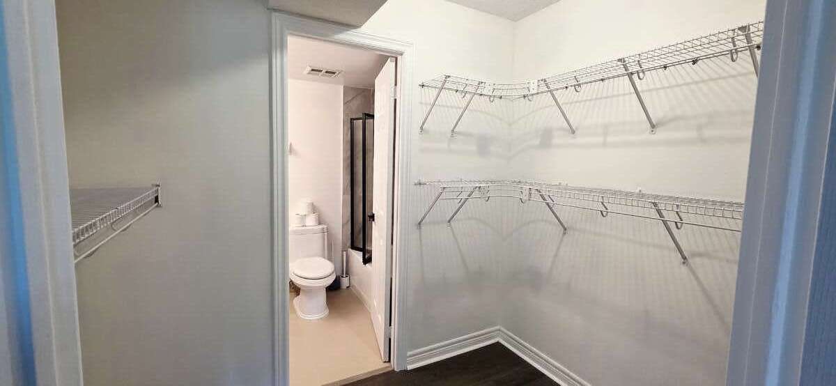 Walk-in closet view to primary ensuite-bath