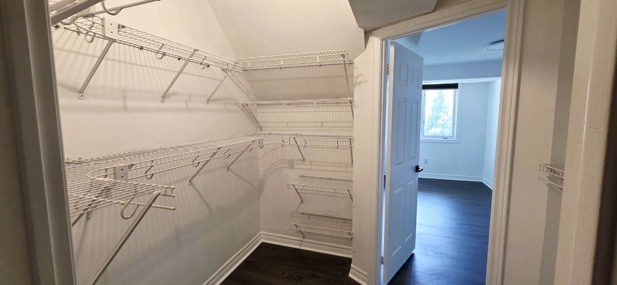 Walk-in closet view to primary bedroom