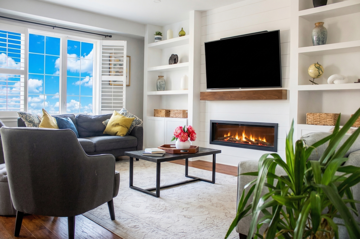 Living area with ornamental molding, electric fireplace, built-in modern wall, and recessed lighting