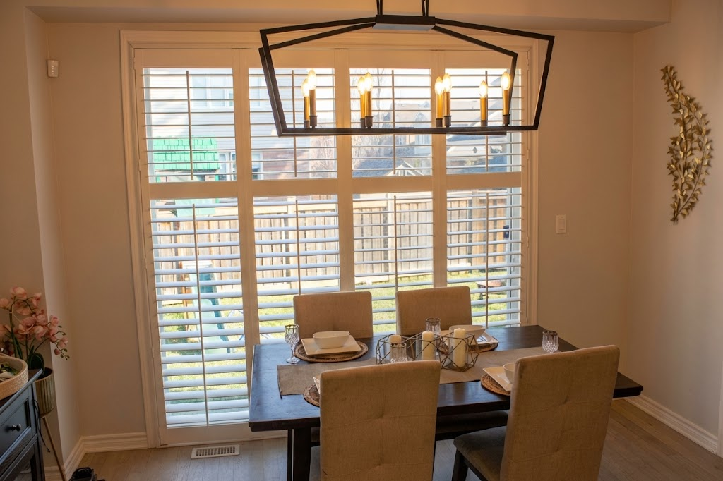 Dining space featuring large sliding windows, california shutter with recessed lighting