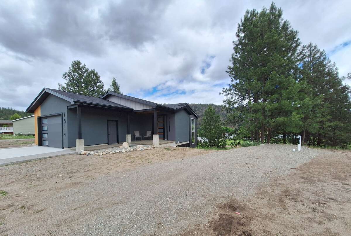 Streetside view and serviced RV area to South of Home.