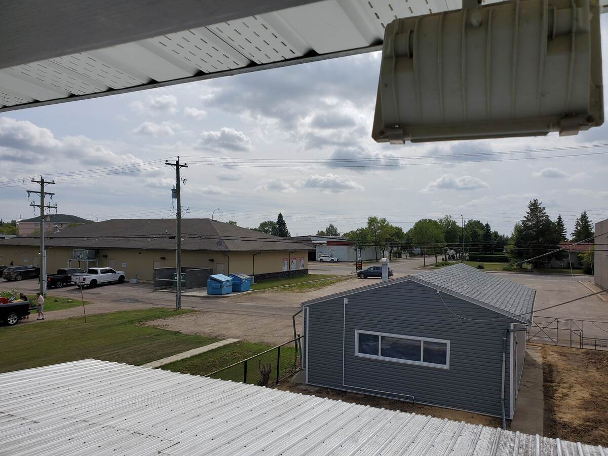 View from upper floor door of back yard and alley