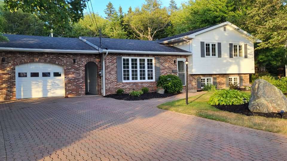 Wide brick-paved driveway can old up to six cars