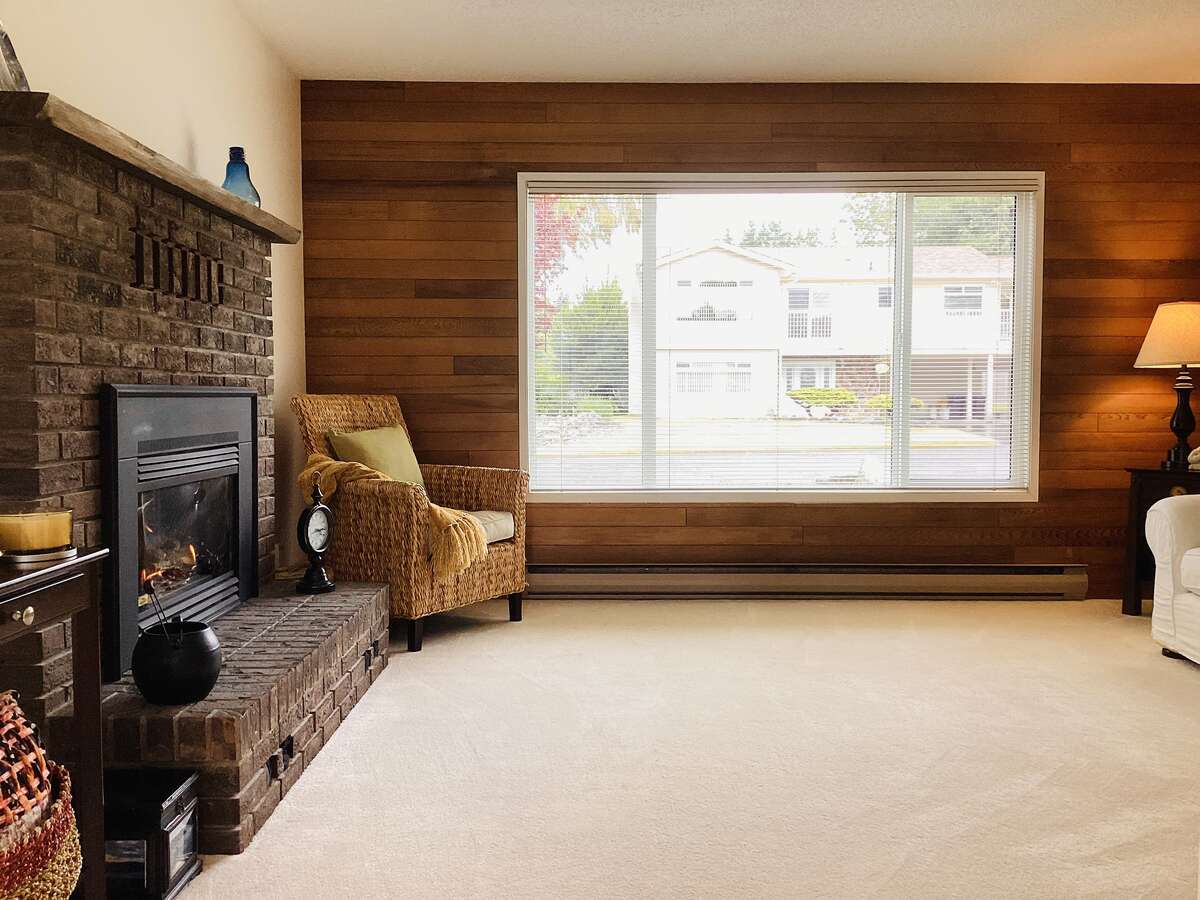 Main house living room with cozy gas fireplace and wood accents