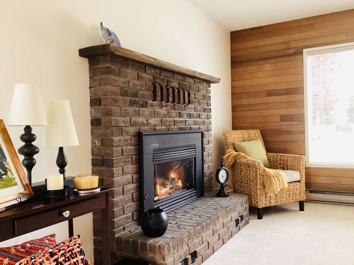 Main house living room with cozy gas fireplace and wood accents
