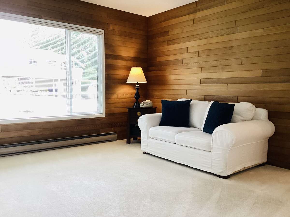 Main house living room with cozy gas fireplace and wood accents