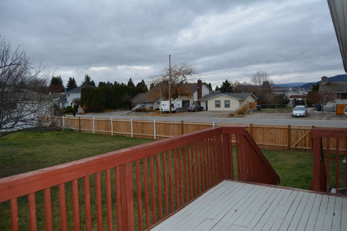 Deck off of kitchen - yard goes beyond fence to the curg