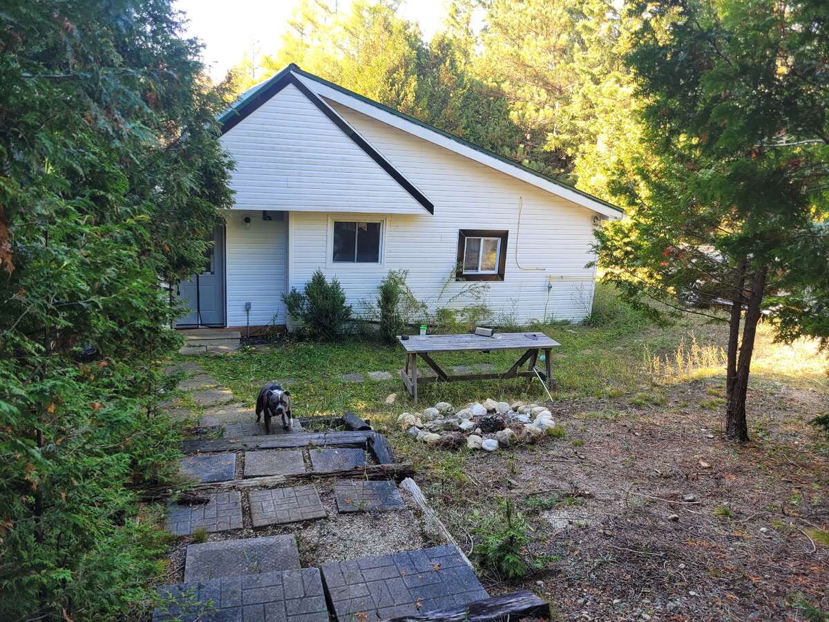 East facing of the cottage with a cedar fort located to the right.