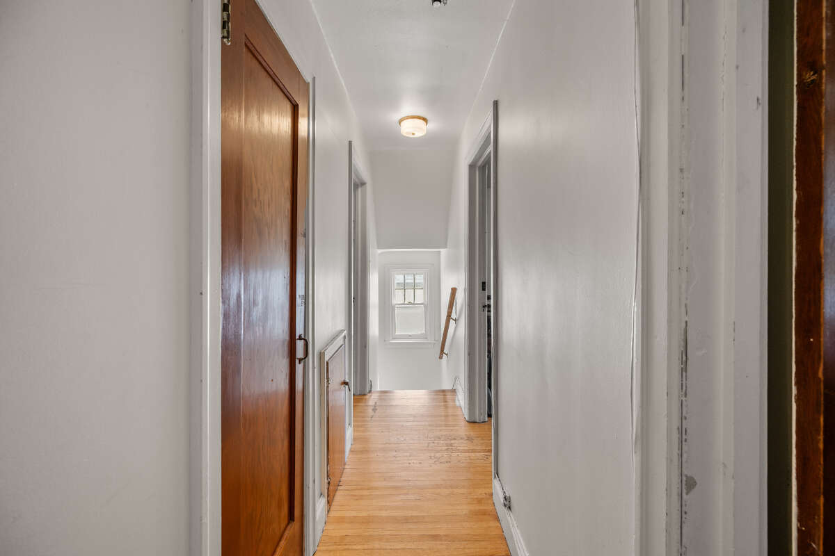 2nd floor hallway leading to stairs and bedrooms/bathroom